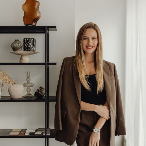Bennett leasing representative in business attire smiling in modern office