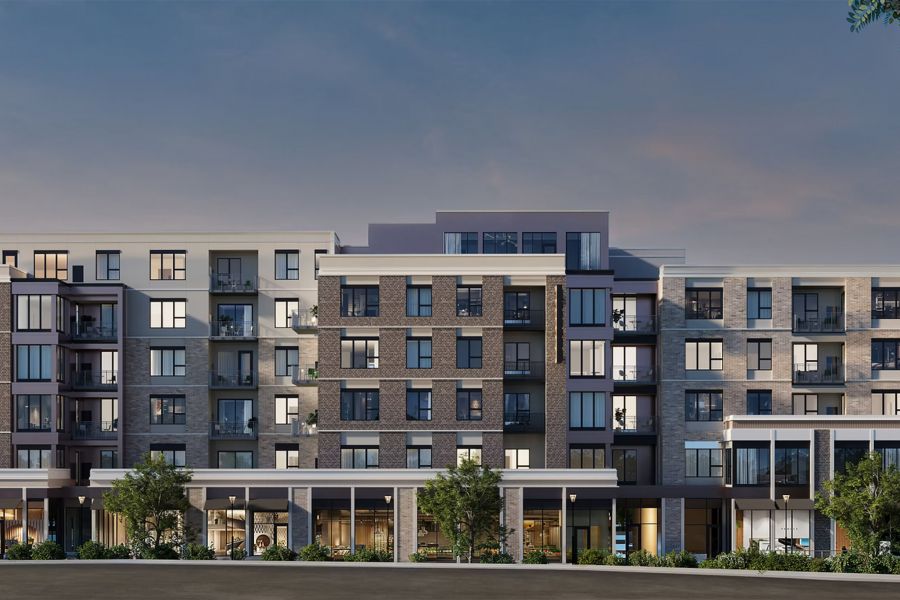 Modern mid-rise apartment building with large windows and balconies at dusk at Bennett Apartments.